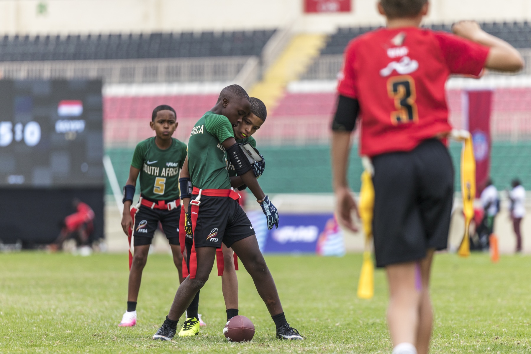 Flag football players preparing for a play